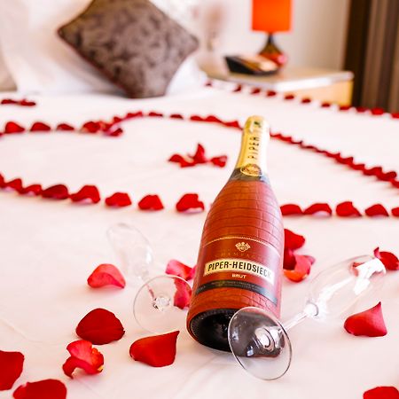 The Boma Nairobi Hotel Exterior photo A bottle of champagne and rose petals on a bed
