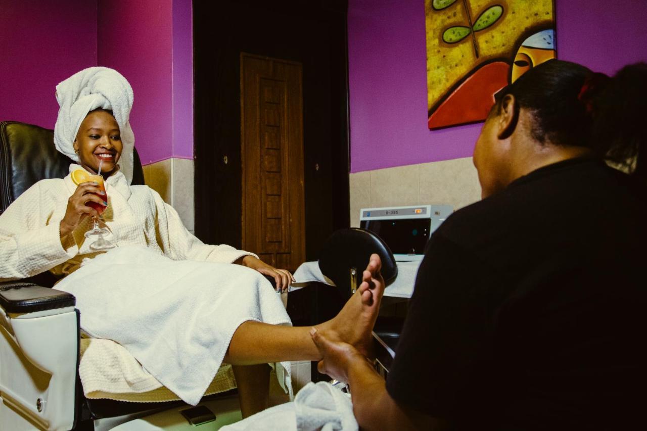 The Boma Nairobi Hotel Exterior photo A woman receiving a pedicure